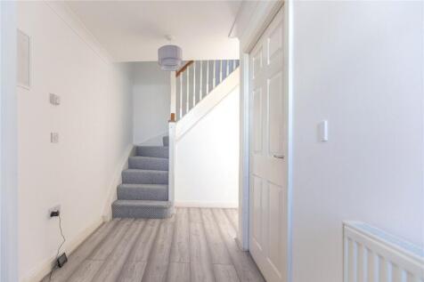 Bright and clean hallway with modern flooring a...