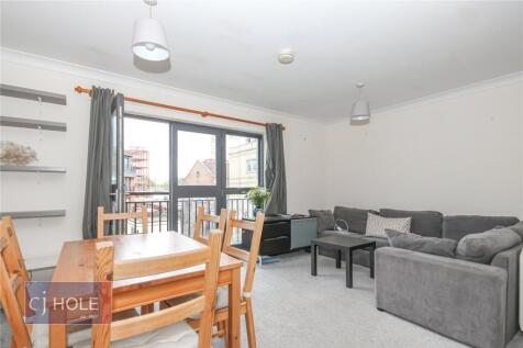 Bright and inviting living room featuring a lar...