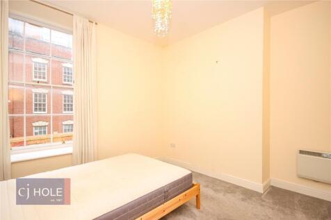 A bright and tidy double bedroom featuring a la...