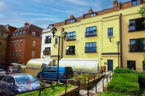 View of a charming residential building with cr...