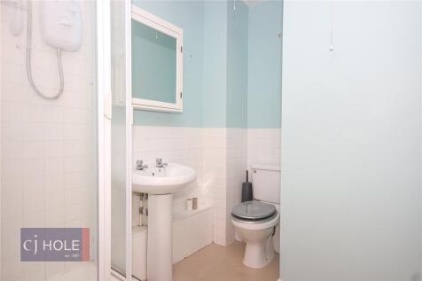 Bright, clean bathroom with a white pedestal si...