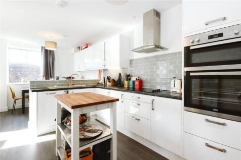 Bright and modern kitchen with sleek white cabi...