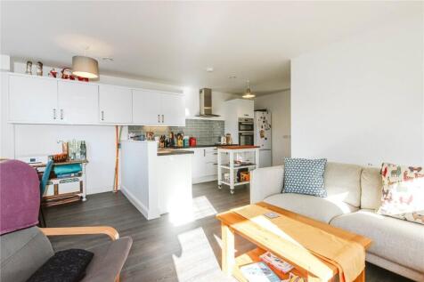 Bright and inviting living room with ample natu...