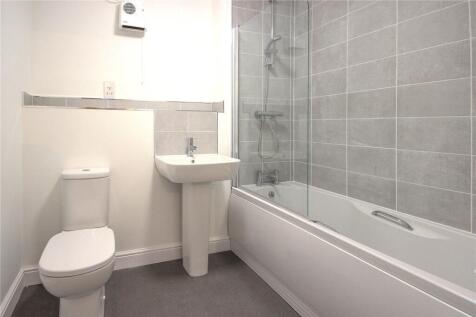 Bright and modern bathroom featuring a full-siz...