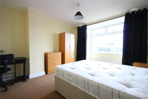 Bright double bedroom featuring a large window ...