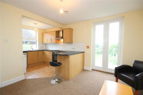 Bright and tidy kitchen area featuring modern w...