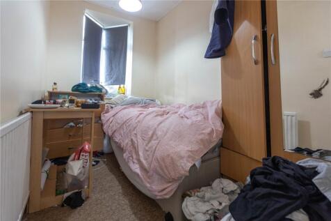 Cozy single bedroom featuring a comfortable bed...