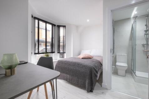 A bright and spacious double bedroom featuring ...