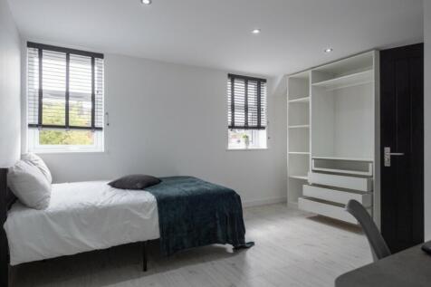 A stylish double bedroom featuring large window...