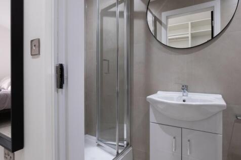 Modern bathroom featuring a sleek shower and co...