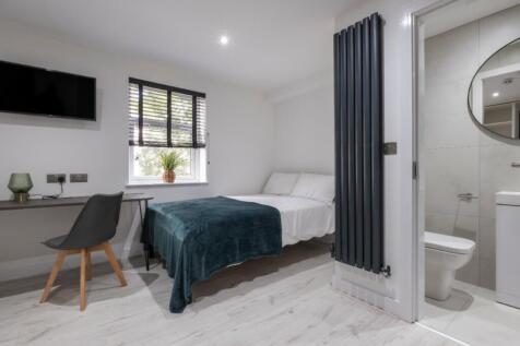 This inviting double bedroom features a comfort...
