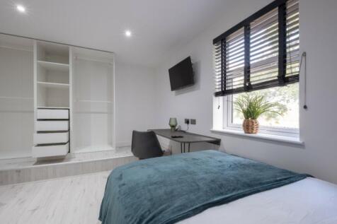 This stylish double bedroom features a comforta...