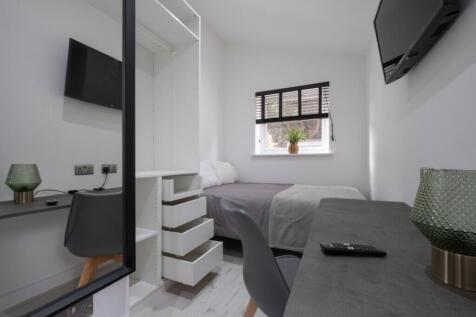 A stylish double bedroom featuring modern decor...