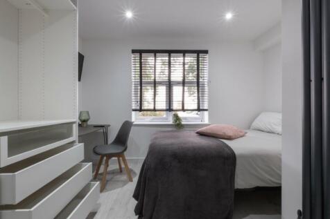 This inviting double bedroom offers a cozy atmo...