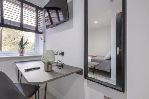 This inviting double bedroom features a stylish...