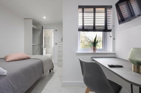 A stylish double bedroom featuring a comfortabl...