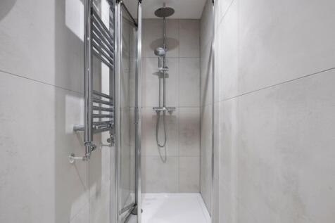 Modern bathroom featuring a sleek shower space ...