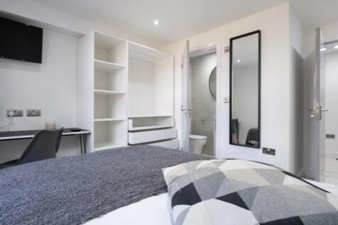Spacious double bedroom featuring modern furnis...
