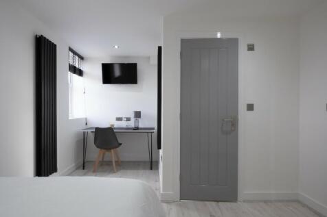 This stylish double bedroom features a comforta...