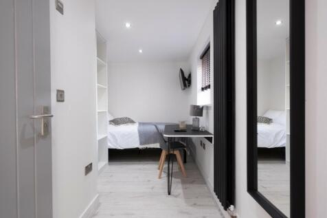 A stylish and modern double bedroom featuring a...