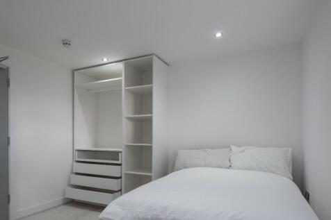 This modern double bedroom features a spacious ...