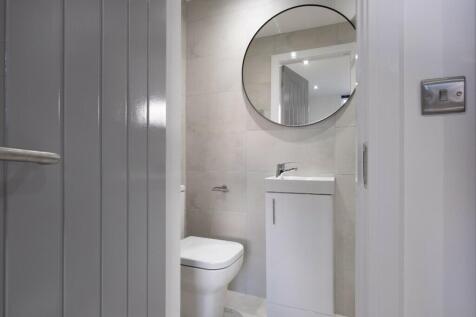 A modern bathroom featuring sleek finishes, a w...