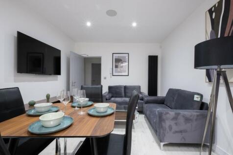 Contemporary living room featuring a stylish di...
