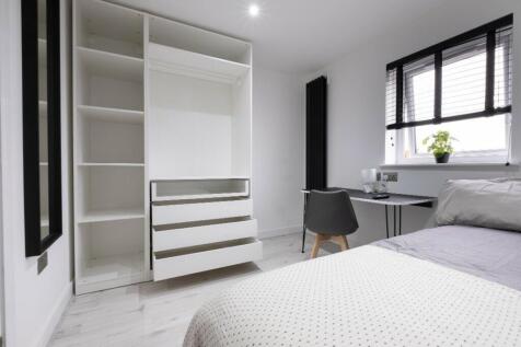 This inviting double bedroom features a modern ...