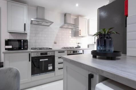 A modern, well-equipped kitchen featuring sleek...