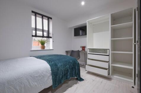 A bright and inviting double bedroom with moder...