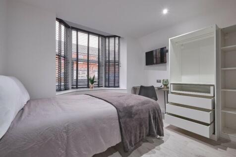 A bright and modern double bedroom featuring am...