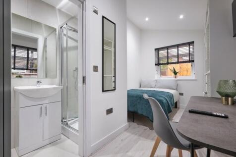 A modern and inviting double bedroom with an en...