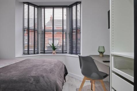 A stylish and well-lit double bedroom featuring...