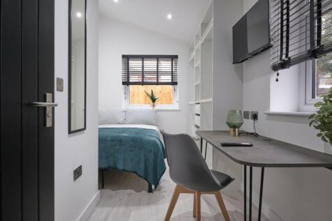 A bright and stylish double bedroom featuring a...
