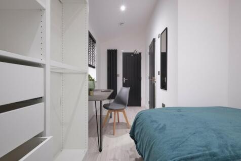 A bright and tidy double bedroom featuring a co...