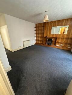 A spacious living room featuring a cozy firepla...