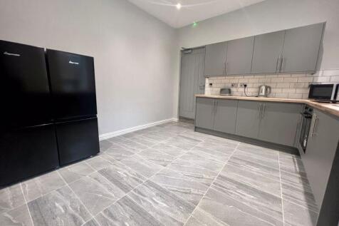 Modern kitchen featuring sleek grey cabinets an...