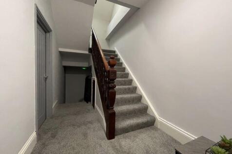 A clean, well-maintained staircase with neutral...