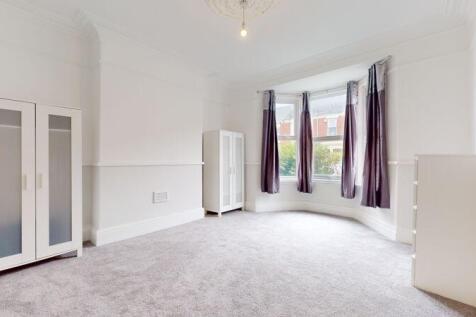 Bright and spacious master bedroom featuring a ...