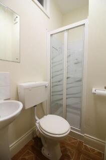 A neat and clean compact toilet room featuring ...