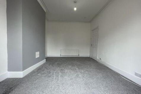 A clean and simple living room with neutral ton...