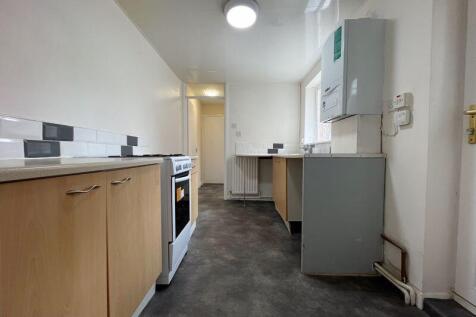 A clean and functional galley kitchen with wood...