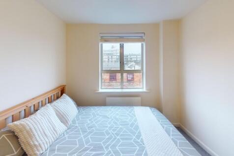 A bright and tidy double bedroom featuring a la...