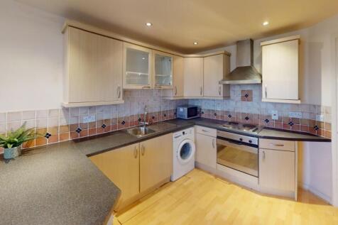 Bright and modern kitchen featuring ample count...