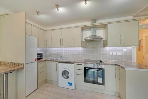 Bright and modern kitchen featuring ample count...