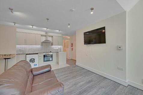 A modern living room with a comfortable leather...