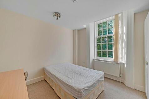 A bright and tidy single bedroom featuring a la...