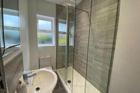 A modern and clean bathroom suite featuring a s...