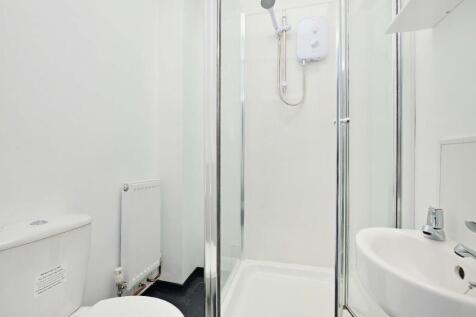 A clean and modern bathroom featuring a shower ...