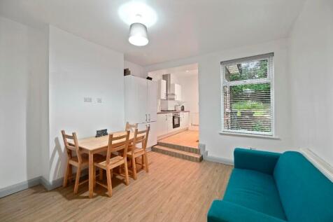 A bright and airy living room featuring a teal ...